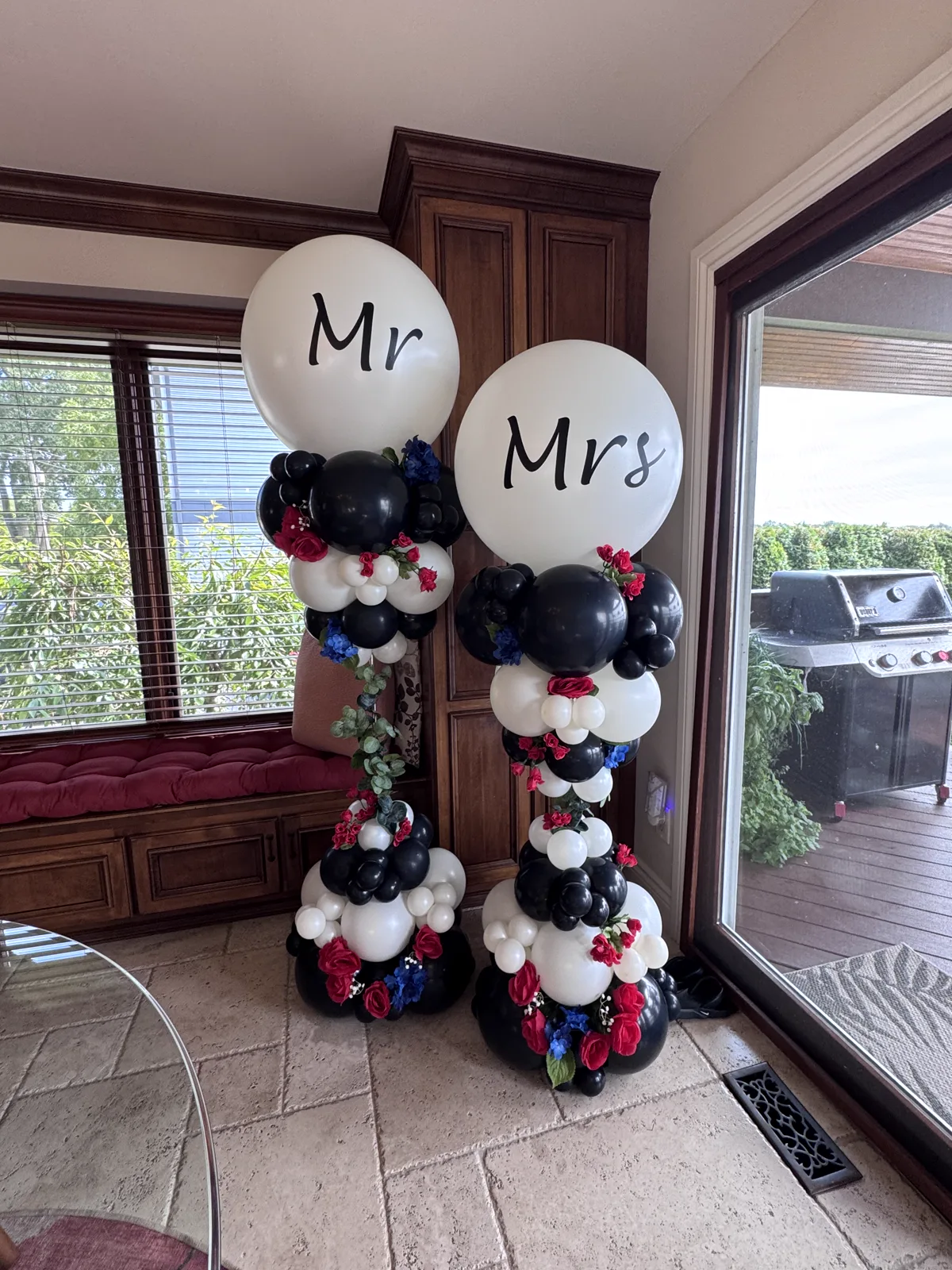 Mr and Mrs jumbo balloon columns in black, white and floral print for a wedding