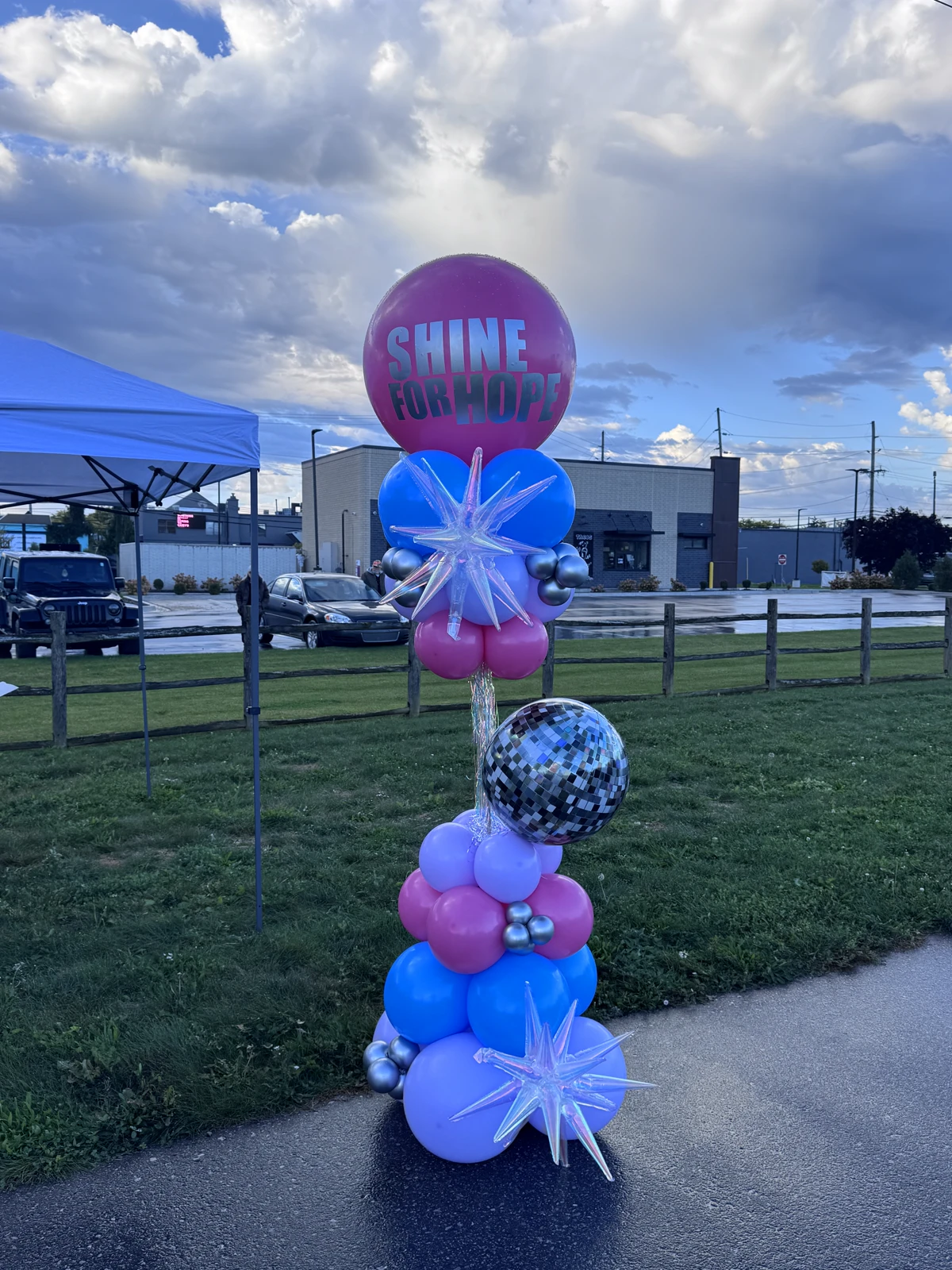 Shine for Hope balloon column in pink, blue and lavender with an iridescent starburst and a disco ball